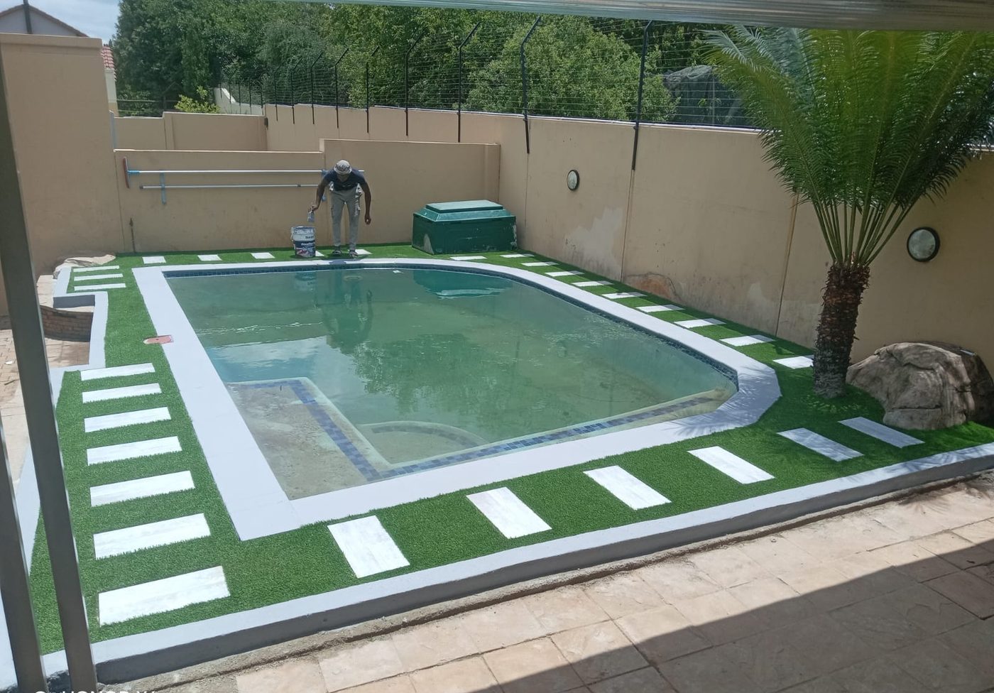 Paving and artificial turf around a pool