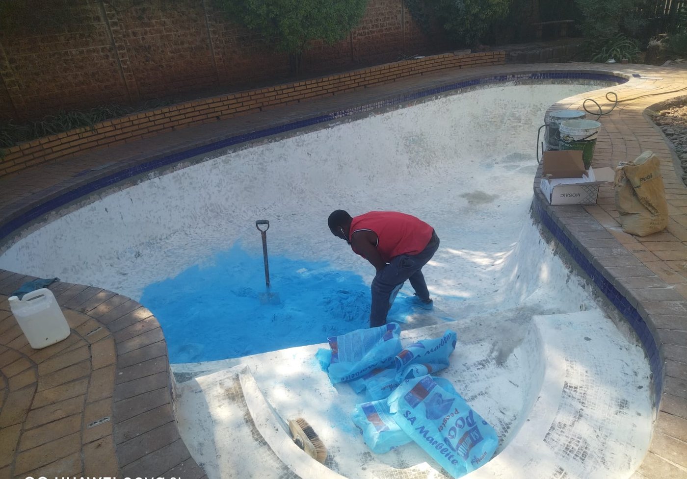 Pool stripped to shell, applying marbelite